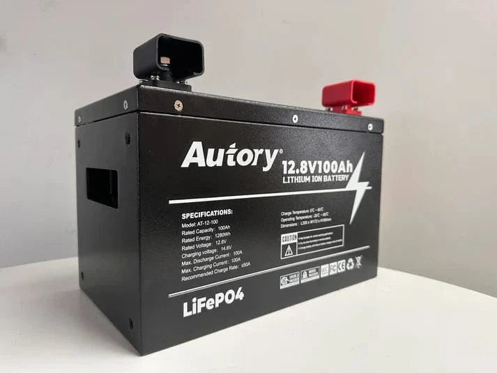 12.8V 100Ah Lithium Battery in metal case with red and black terminals, ideal for caravans and off-grid setups.